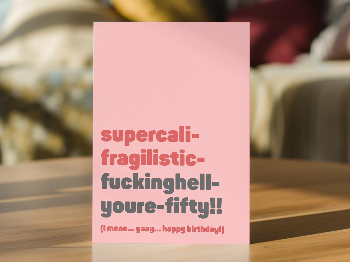 A pink 50th birthday card with bold text reading 'supercali-fragilistic-fuckinghell-youre-fifty!! (I mean. yay... happy birthday!)