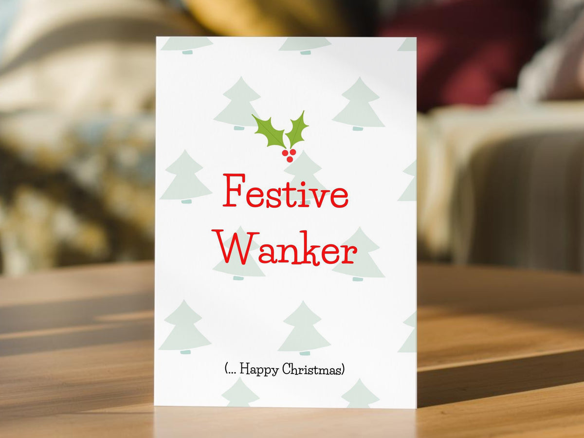 A white funny Christmas card with the text 'Festive Wanker' in red