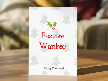A white funny Christmas card with the text 'Festive Wanker' in red