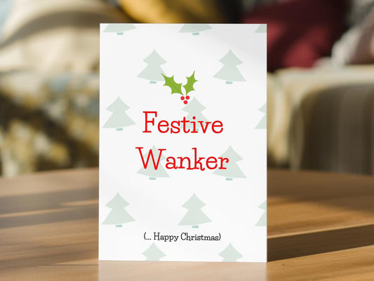 A white funny Christmas card with the text 'Festive Wanker' in red
