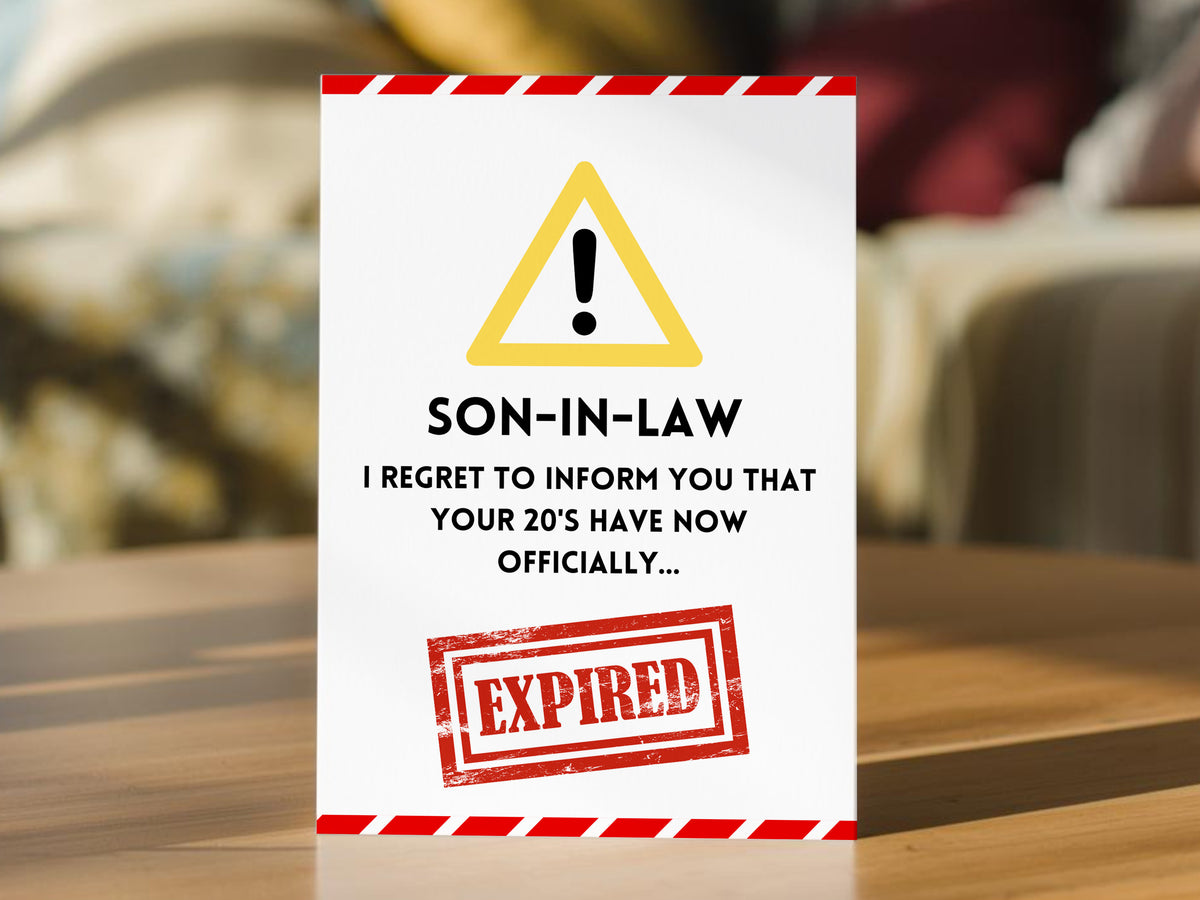 A funny son-in-law 30th birthday card. The card is white with a red and white hazard border, a yellow warning triangle, black text reading 'SON-IN-LAW I REGRET TO INFORM YOU THAT YOUR 20'S HAVE NOW OFFICIALLY.